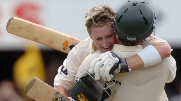 Australian batsman Michael Clarke, left, is congratulated by Adam Gilchrist after scoring his debut home century, at the Gabba against New Zealand.