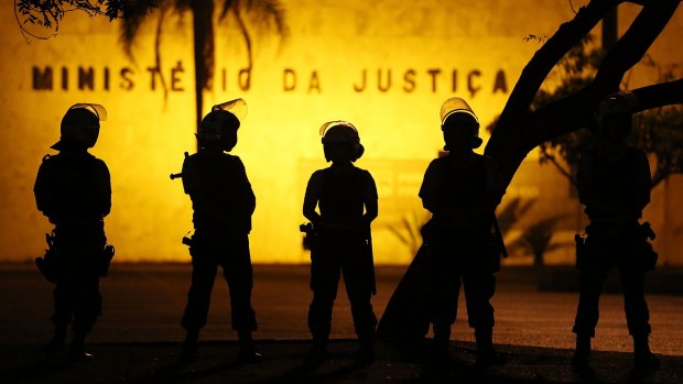 Police keep watch outside the Justice Ministry during protests.