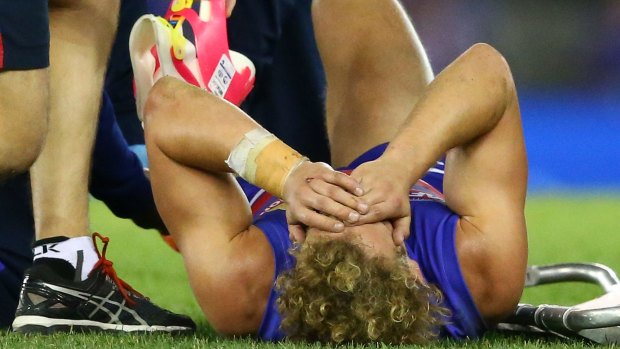 Mitch Wallis lies on the field in agony.