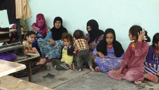 Refugees sit in the school in Ramadi.