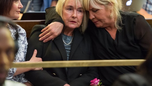 Reeva Steenkamp's mother June clutching a rose (centre) was present at South Africa's Supreme Court of Appeals.