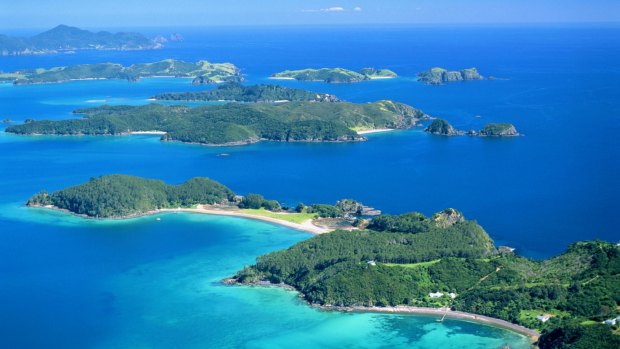 The warm, azure waters and sandy beaches of the Bay of Islands beckon.