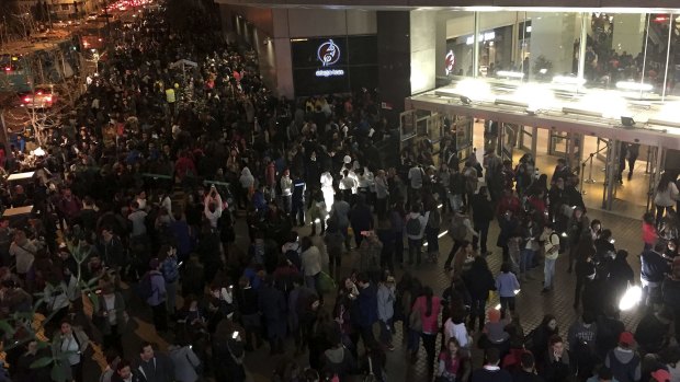 People evacuate a mall in Santiago after a powerful earthquake, in Santiago, Chile.