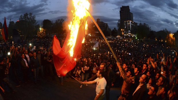 Demonstrators set fire to a Turkish flag during a torch-bearing march marking the anniversary of the 1915 mass killings of Armenians in the Ottoman Empire, in the capital of Armenia, Yerevan, on April 23 last year. 