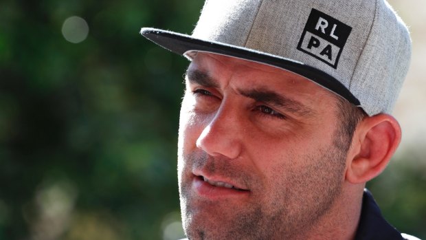 Queensland captain Cameron Smith sports the RLPA flat cap supporting the players' campaign.
