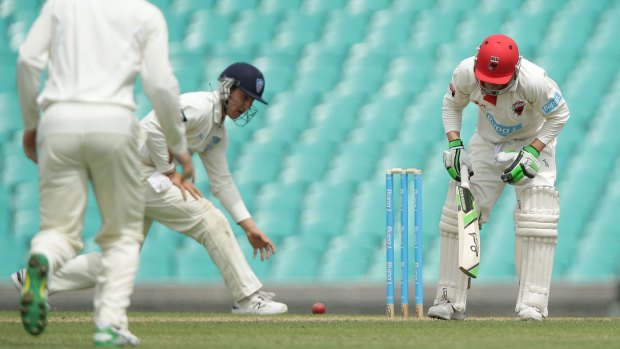 Phil Hughes staggers after he was struck with the ball. 