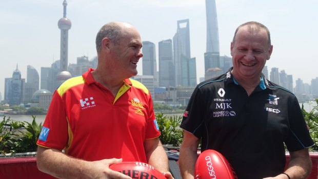 Gold Coast Suns coach Rodney Eade with Port Adelaide coach Ken Hinkley in front of the Pudong skyline in Shanghai.