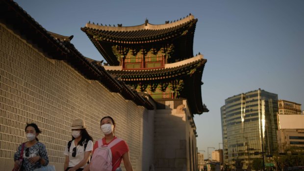 People wearing face masks outside the Gyeongbokgung palace in Seoul on Wednesday. 
