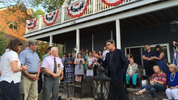 US presidential hopeful Rick Perry turns up for a pre-arranged neighbourhood party hosted by Terry and Rob Hampton at their home.
