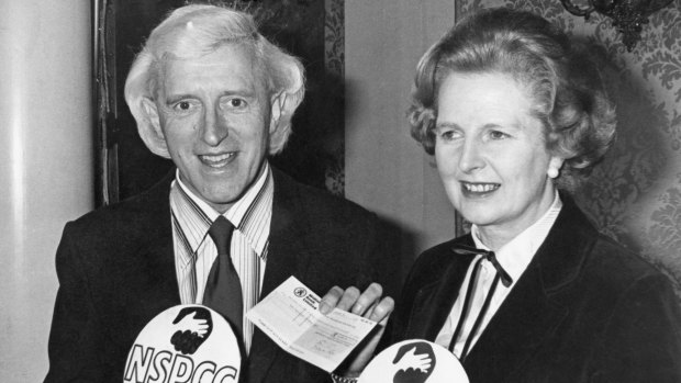 British Prime Minister Margaret Thatcher with English DJ television presenter Jimmy Savile at a fundraising event in 1980. 