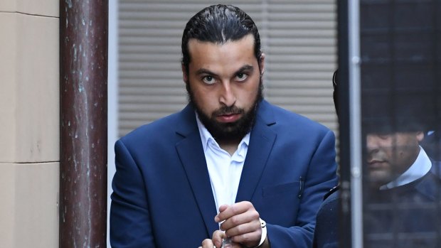 Omar Rajab is led from the Supreme Court in Sydney to a waiting prison vehicle on Friday.