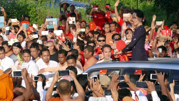 Myanmar opposition leader Aung San Suu Kyi greets supporters upon arrival at an election campaign rally for her National League for Democracy party on Sunday.