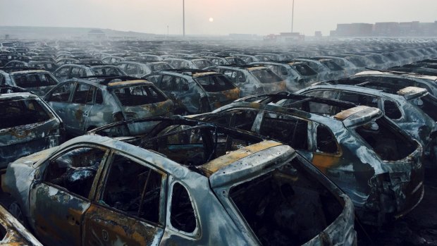 The wrecks of cars smoke after the explosion.