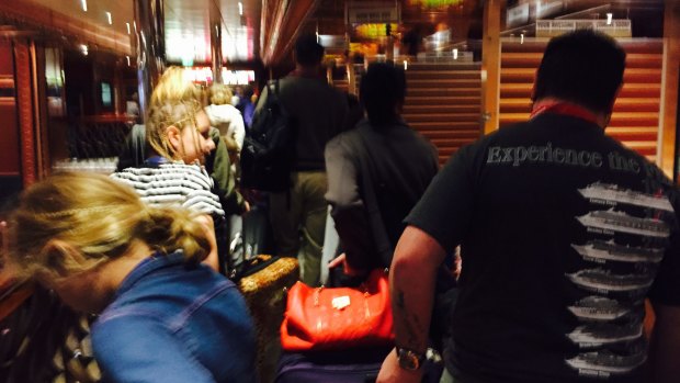 Get me outa here: passengers disembark the Carnival Spirit on Wednesday.