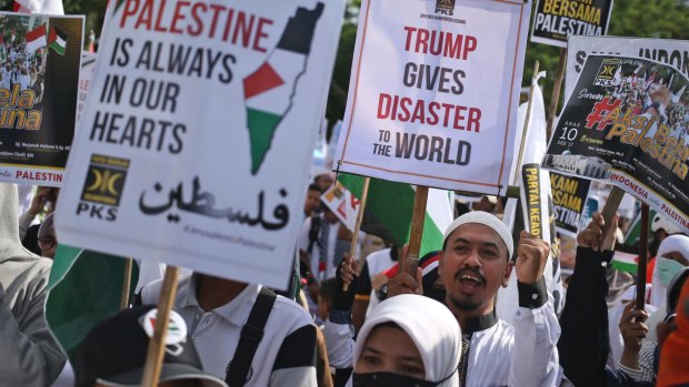Muslims hold posters during a rally against US President Donald Trump's decision to recognise Jerusalem as Israel's capital outside the US Embassy in Jakarta, Indonesia.