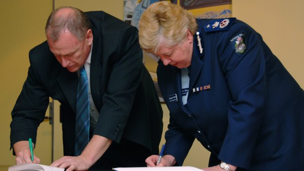 In happier times: Police Association boss Paul Mullett and chief commissioner Christine Nixon sign a police pay deal in 2007.