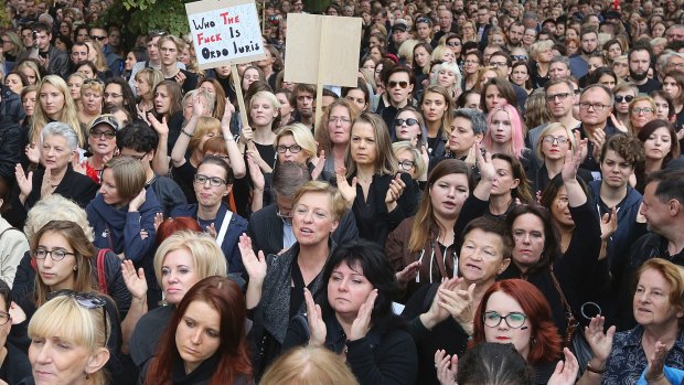 People attend the anti-government, pro-abortion demonstration in front of Polish Pariament in Warsaw.