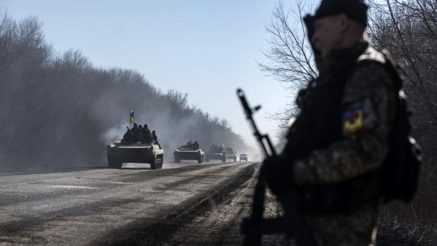 Ukrainian troops ride on armoured vehicles near Artemivsk, eastern Ukraine, 
