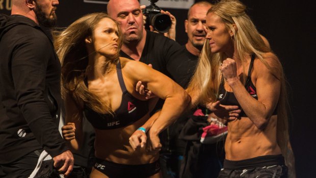 Ronda Rousey (left) confronts Holly Holm during their weigh-in at Melbourne's Etihad Stadium prior to the main UFC event.