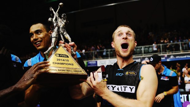 Champions: Breakers guard Rhys Carter celebrates with the trophy after winning game two of the NBL Grand Final series between the New Zealand Breakers and the Cairns Taipans in Auckland.
