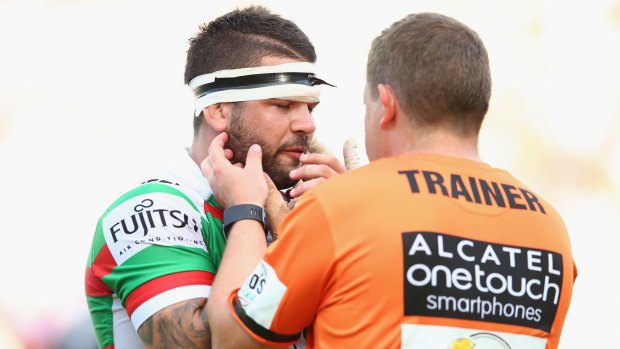 In a world of hurt: Adam Reynolds receieves attention from the trainer.