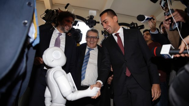 5-Star Movement leader Luigi Di Maio greets Paolo Pepper, an a robot at the 'Tourism 2030' convention Milan, Italy, last week.
