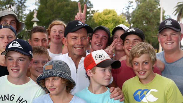 Former prime minister Tony Abbott poses for a photo with students in Forbes during the 2016 Pollie Pedal tour.