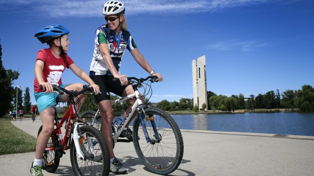 Max Millgate, 8, of Hughes, enjoys a ride around Lake Burley Griffin with his mother Sally Clark.