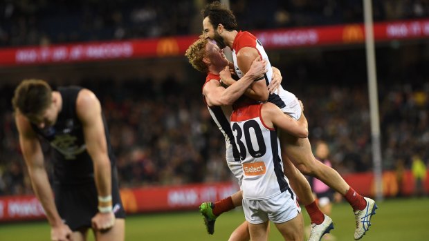 In the mix: Melbourne players after their hard-fought comeback win over Carlton.