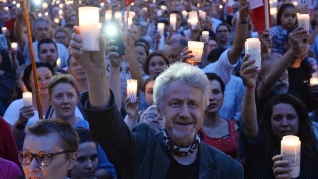 People gather for a candle lit protest in front of the Supreme Court in Warsaw, Poland, July 24, 2017.