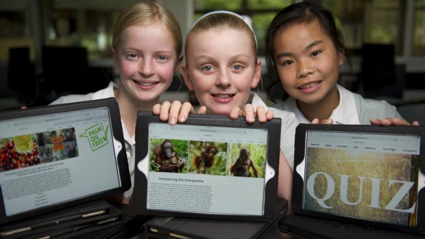 Canberra Girls Grammar fifth-graders Evie Lane, Lauren Faulder and Emily Nguyen with the prize-winning website they built to raise awareness of orangutans.