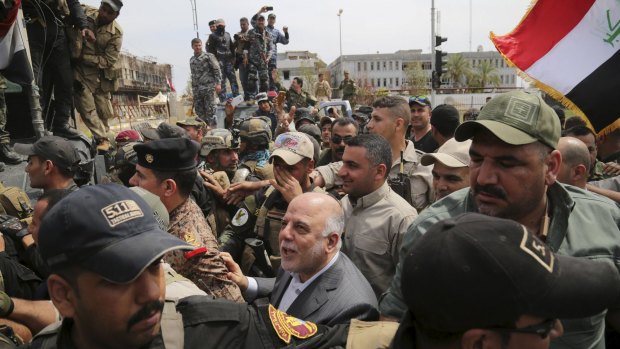 Iraq's Prime Minister Haidar al-Abadi Tikrit after Iraqi security forces regained control from Islamic State militants.