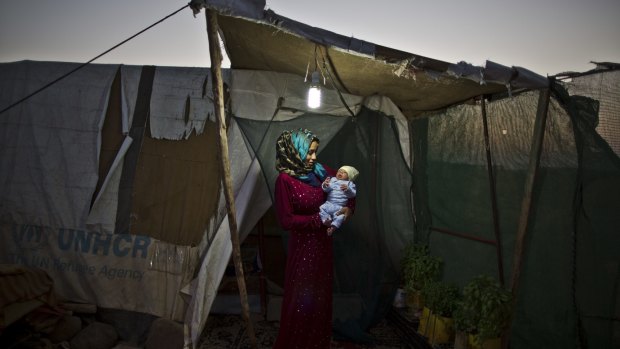 Syrian refugee Huda Alsayil, 20, holds her newborn son Mezwid at an informal settlement on the outskirts of Mafraq, Jordan.