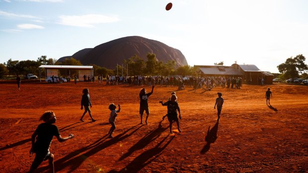 Local children play Aussies rules during the First Nations national convention at Uluru.