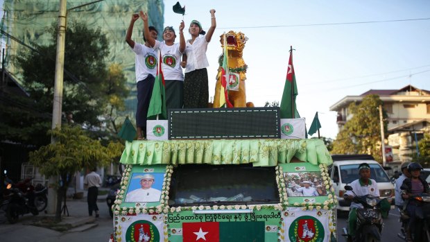 Supporters of Myanmar's military-backed Union Solidarity and Development Party (USDP) dance on a truck decorated with USDP party logos and pictures of the leaders in Mandalay on Tuesday.