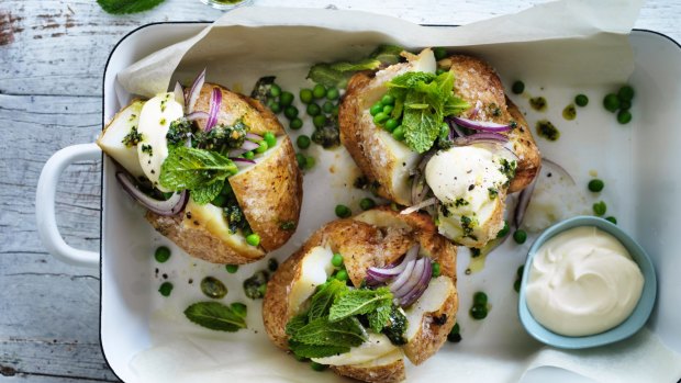 Baked potatoes with peas and rough pesto.
