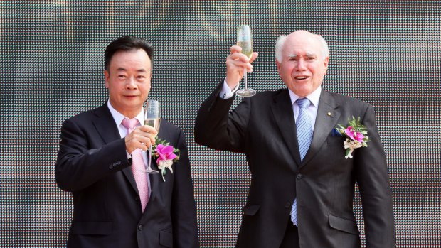 Chau Chak Wing and John Howard share a toast in 2011. 