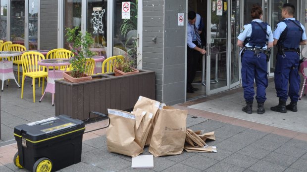 Police search the Vy Vy Garden Cafe in Canley Heights on January 19 as part of an investigation into a international money laundering syndicate.