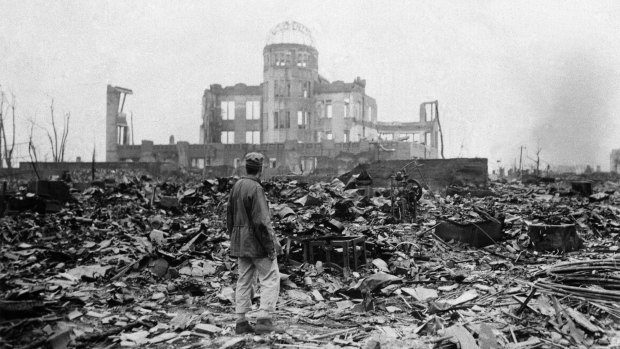 An Allied correspondent stands in the rubble of a building that once was a movie theatre in Hiroshima, on Sepember 8, 1945, after the nuclear bomb was dropped.