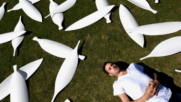 History man ... Jonathan Jones with some of the 15,000 shields that form part of his installation.