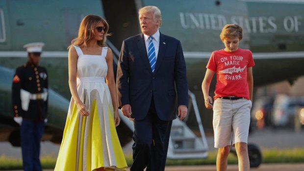 In this August 20, 2017 photo, President Donald Trump, first lady Melania Trump and son Barron Trump walk across the tarmac before boarding Air Force One at Morristown Municipal Airport in Morristown, New Jersey.