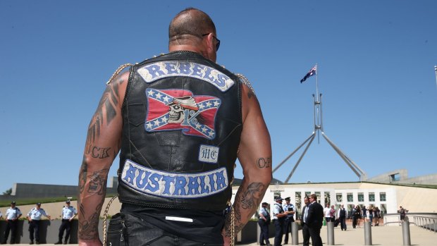 A motorbike rider protesting bikie laws arrives on the front lawn of Parliament House on December 1 last year.