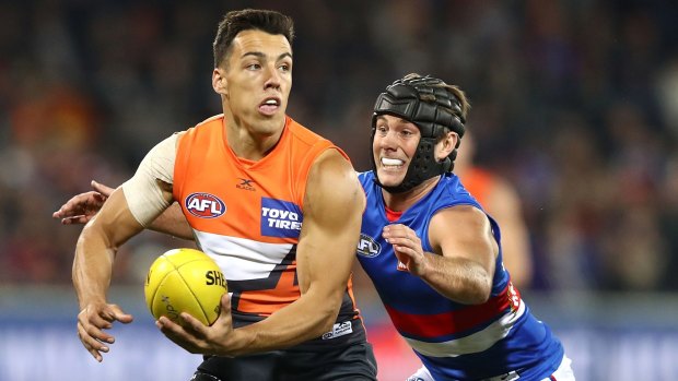 CANBERRA, AUSTRALIA - APRIL 28: Dylan Shiel of the Giants is tackled by Caleb Daniel of the Bulldogs during the round six AFL match between the Greater Western Sydney Giants and the Western Bulldogs at UNSW Canberra Oval on April 28, 2017 in Canberra, Australia. (Photo by Ryan Pierse/Getty Images)