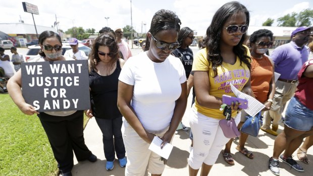 Protesters pray at a rally outside the Waller County Courthouse in July after a march from the Waller County Jail in Hempstead, Texas, to protest the death of Sandra Bland, who was found dead in the jail. 