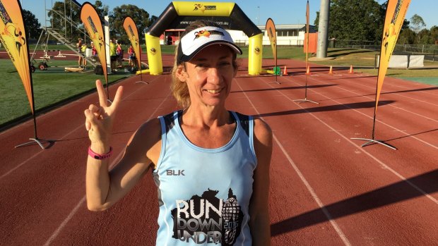 Jodie Oborne signals "two" as the second ever finisher of the 14,080-kilometre Run Down Under virtual race.