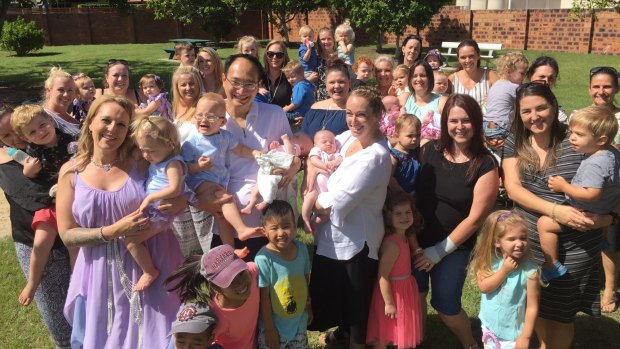 Monash IVF specialist Dr Kee Ong with 20 happy families he helped create during his nine-year career on the Gold Coast.