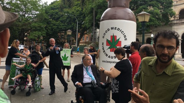 One Nation MP Steve Dickson, Independent MP Rob Pyne and councillor Jonathan Sri lead a rally supporting medicinal cannabis outside Queensland Parliament.