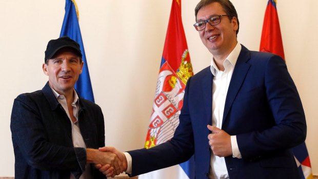 British actor and director Ralph Fiennes, left, shakes hands with Serbian President Aleksandar Vucic, during a meeting in Belgrade, Serbia, on Sunday.