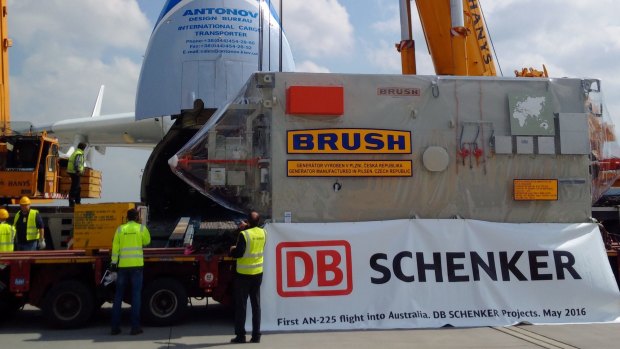 A massive generator, delivered by the Antonov, in manouevred onto the back of a special truck.