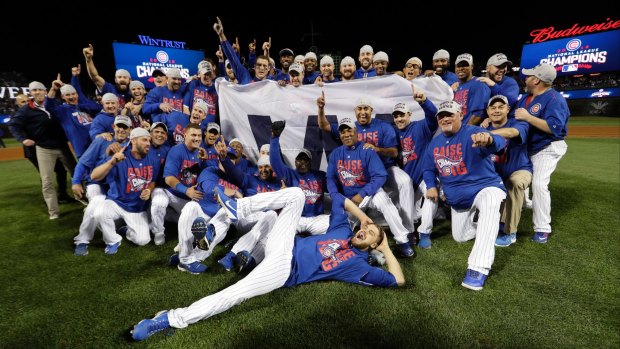 Cubs players celebrate ending the pennant drought.